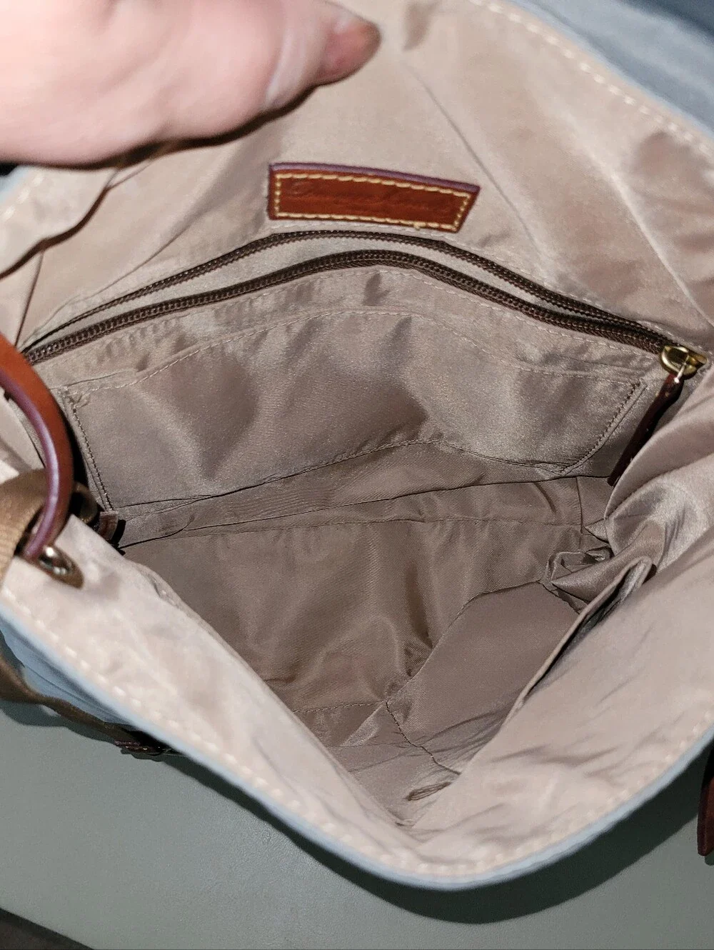 Dooney & Bourke Light Gray Nylon Backpack with Brown Leather Trim.